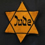 Yellow badge Star of David called "Judenstern". Part of the exhibition in the Jewish Museum Westphalia, Dorsten, Germany. The wording is the German word for Jew (Jude), written in mock-Hebrew script. From Wikipedia page.